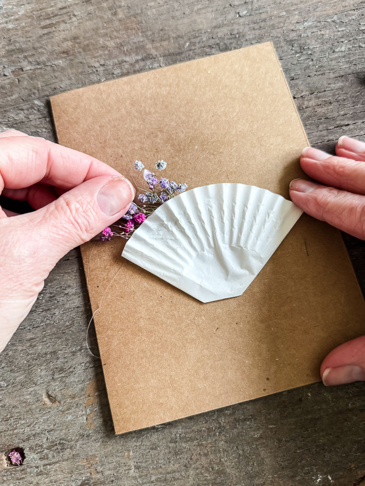 adding baby's breath to a cupcake liner on a card
