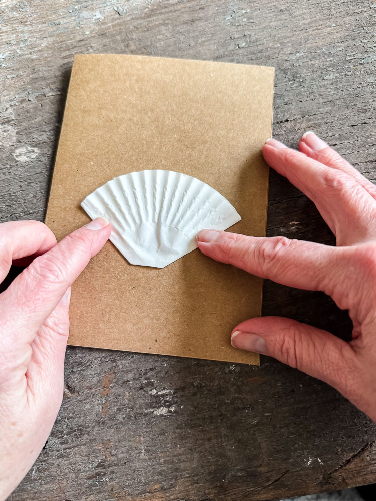 gluing a cupcake liner onto a brown card