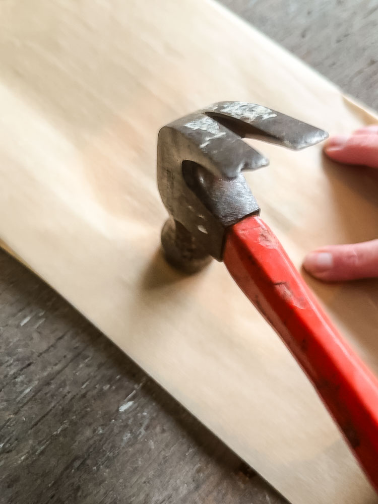 using the flower pounding method to make a card. here is a hammer and a piece of brown parchment paper