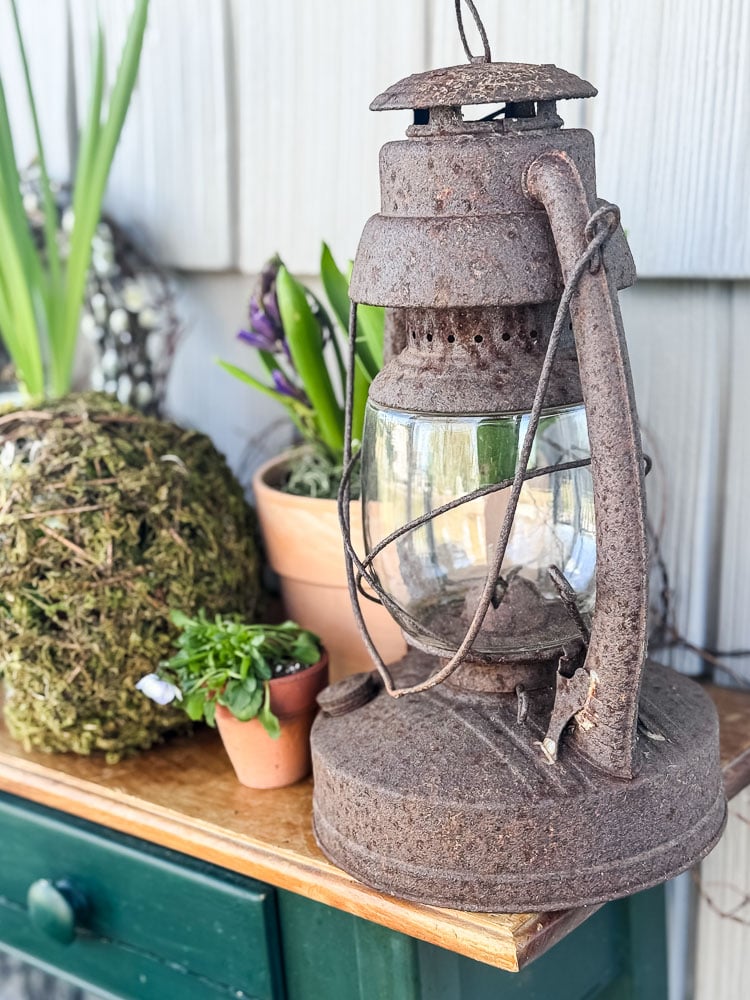 rusty lantern on a spring porch table