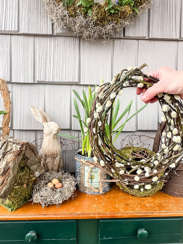 holding a pussy willow wreath