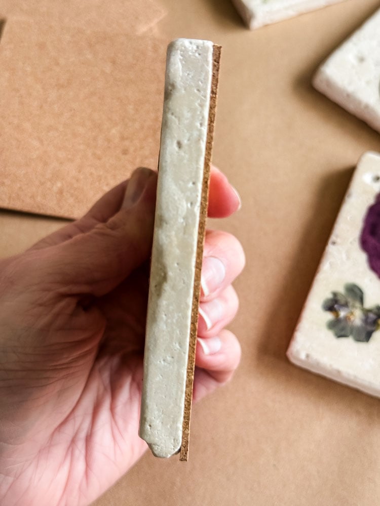 a hand holding a coaster sideways