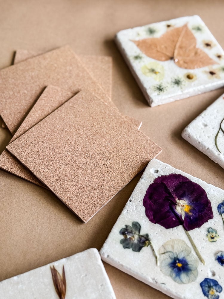 cork squares, flower coasters on brown paper background