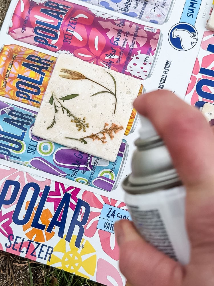 spraying a topcoat on a tile coaster project