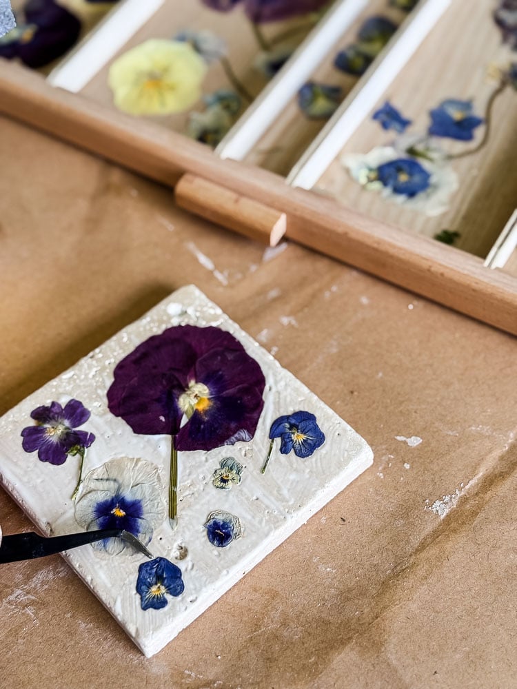making a coaster with pansies on top