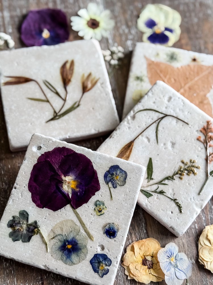 tile coasters with pressed flowers on the surface styled