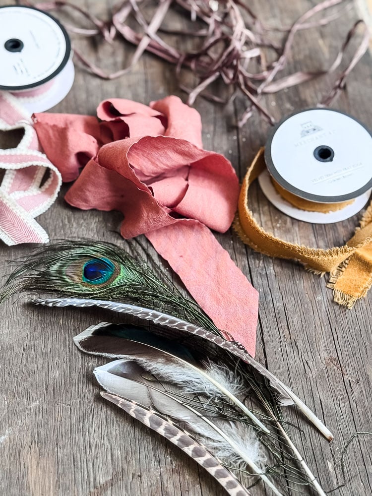 pile of rolls of ribbon and feathers
