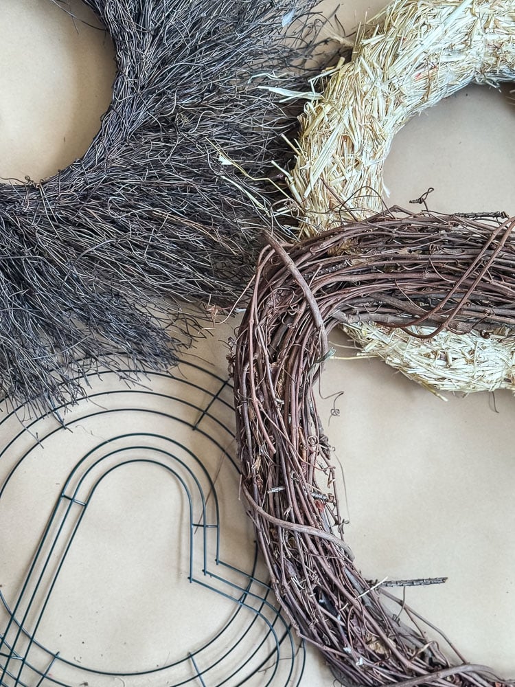 a flatlay of different types of wreath forms including wire, grapevine, and straw