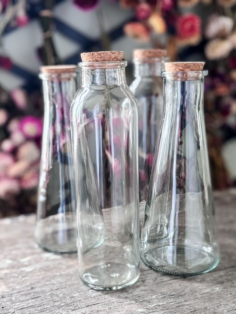 4 glass bottles with corks