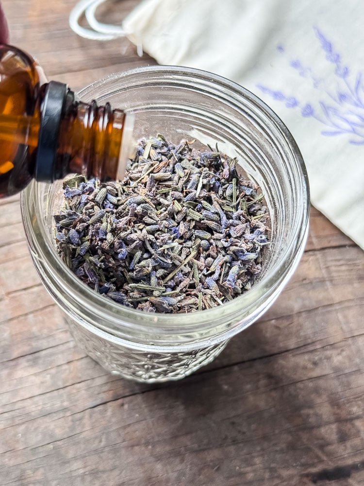 adding lavender oil to a jar of lavender