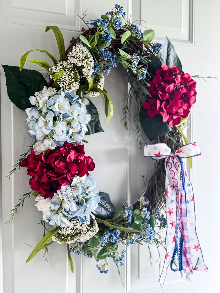 red,white,blue flower wreath on front door