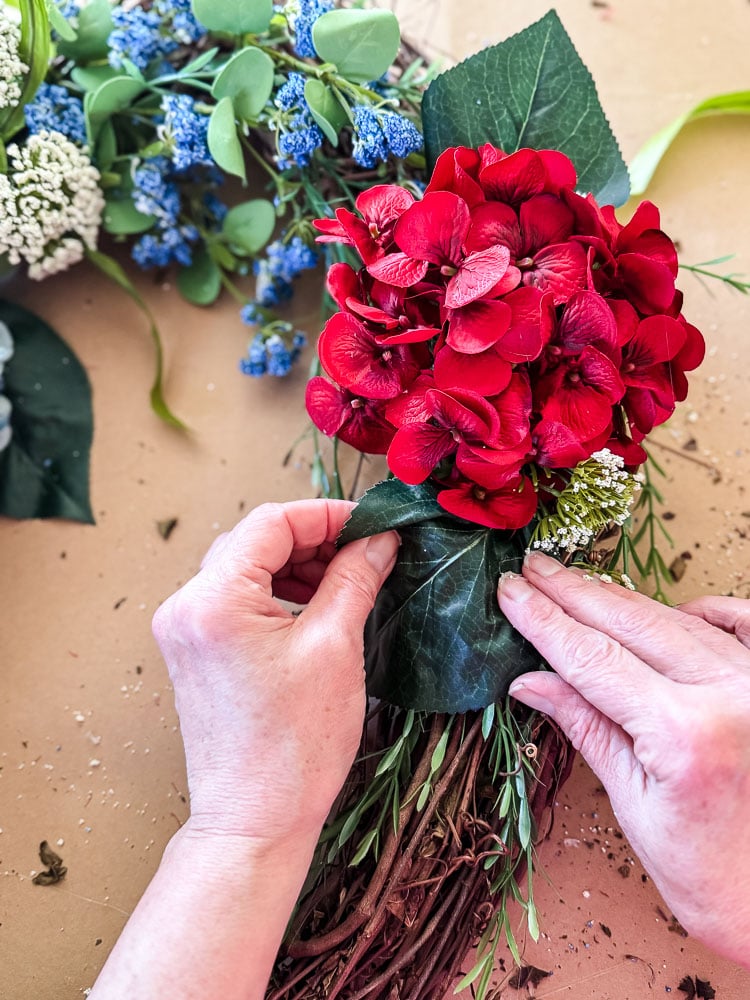 glueing a hydrangea to a wreath