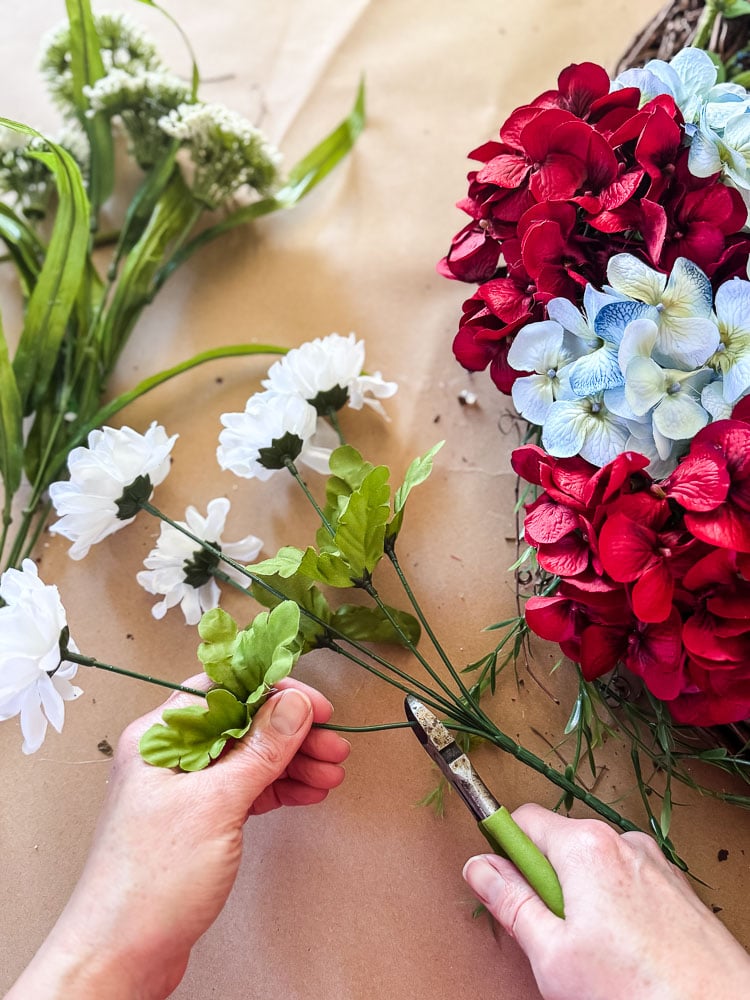 cutting fake flower stems with wire cutters
