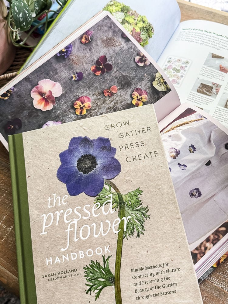 books on pressing flowers and flowers on a coffee table