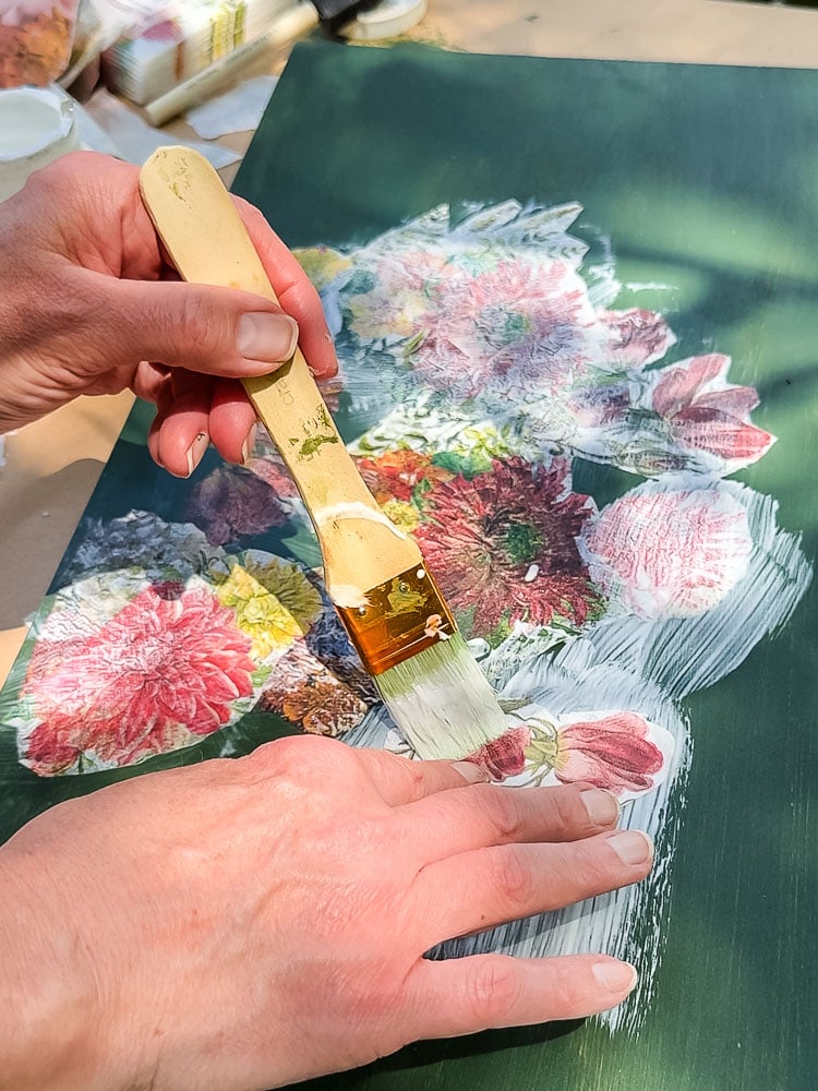 decoupaging flower napkon on green wood board