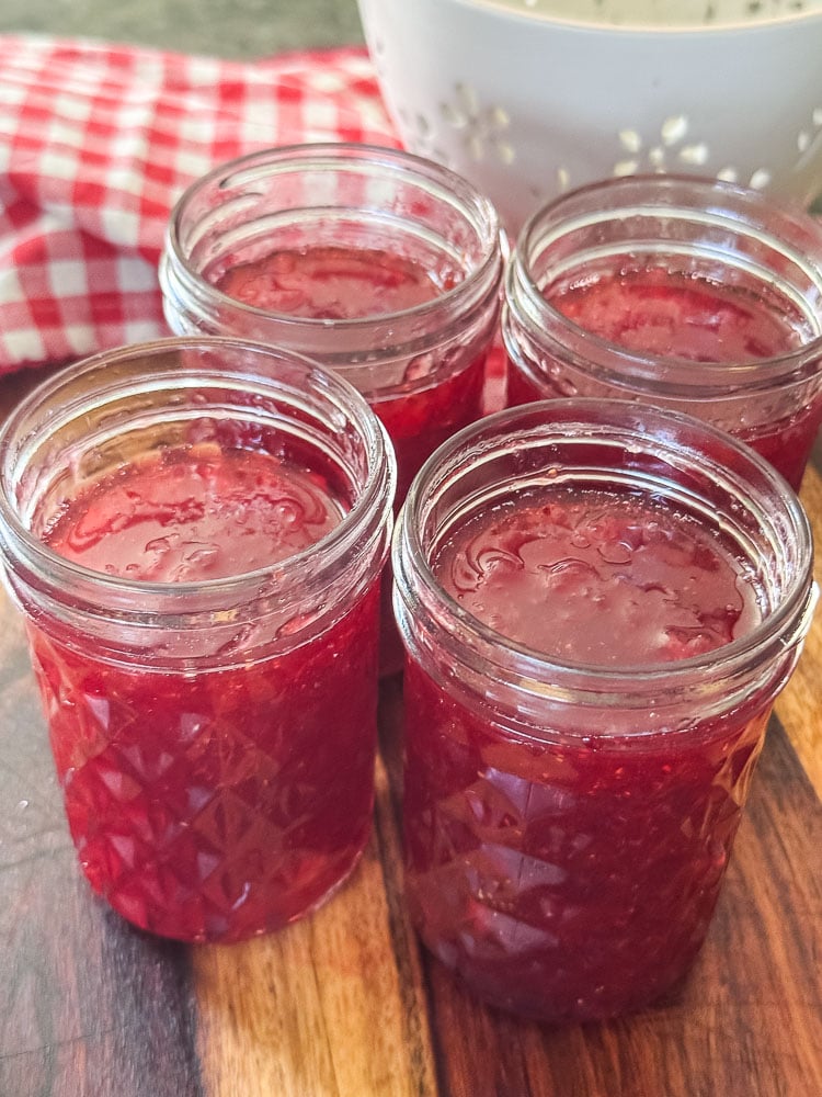 4 filled jam jars with homemade strawberry jam