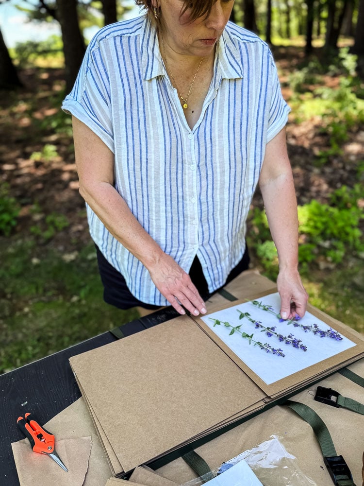 Jennifer Howard filling a flower press outside