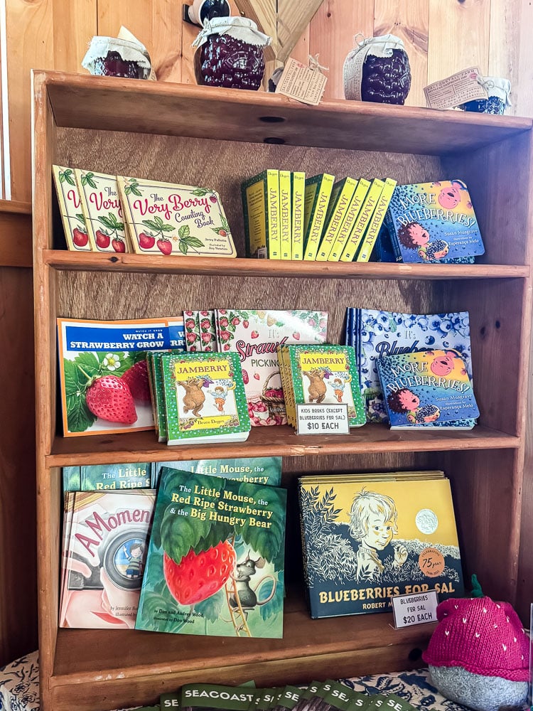 a bookshelf with kid's books about berries