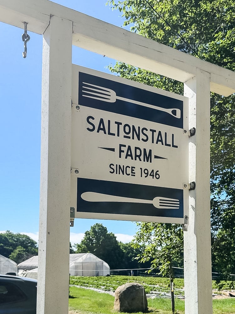 a large road sign that says saltonstall farm