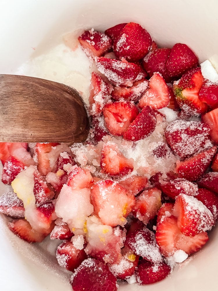 stirring ingredients to make strawberry jam