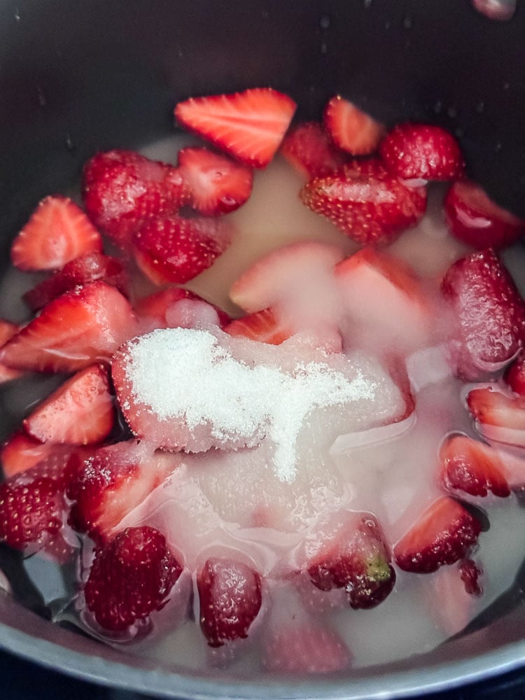 strawberries in a pan with sugar and water