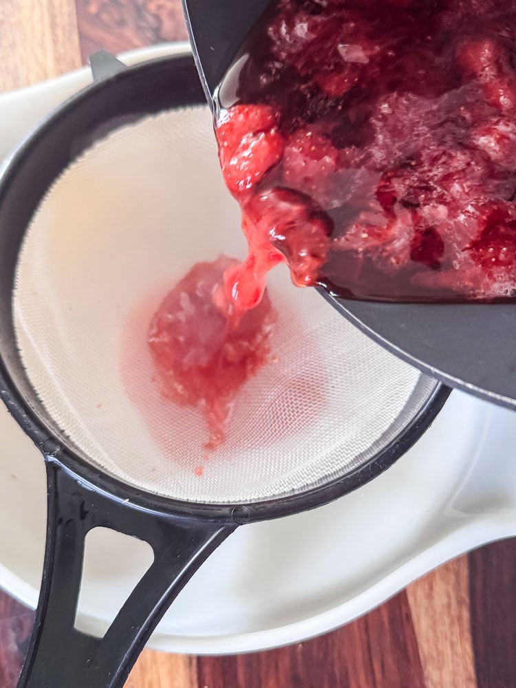 straining cooked strawberries