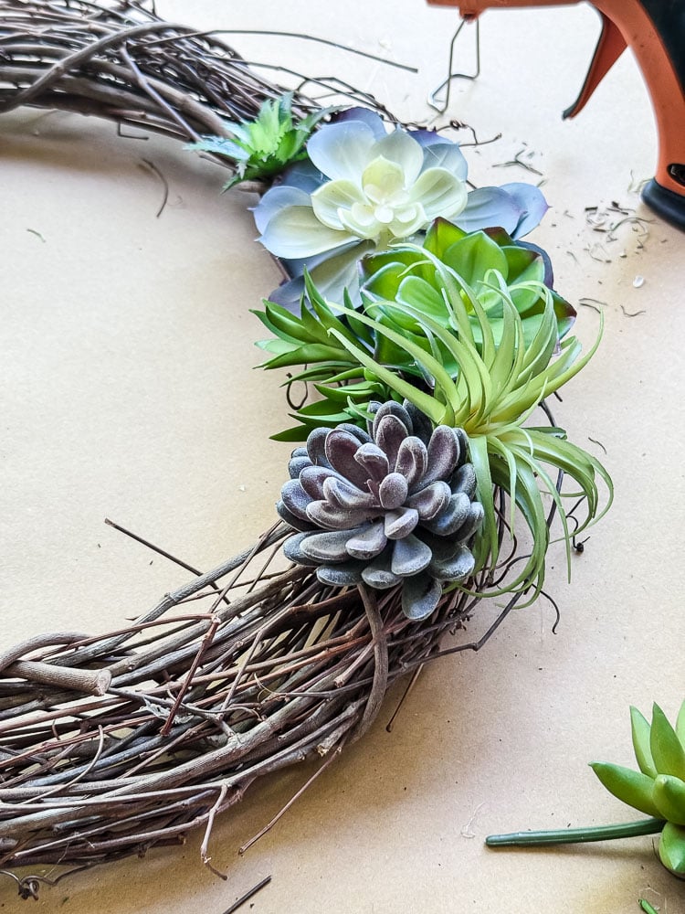 an artificial succulent wreath being made