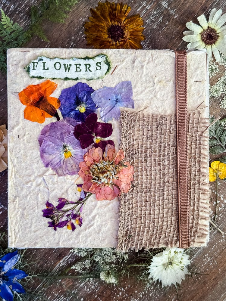 a journal cover with real pressed flowers glued to it