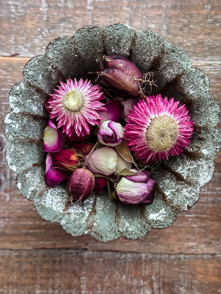 dried flowers in a metal decorative dish