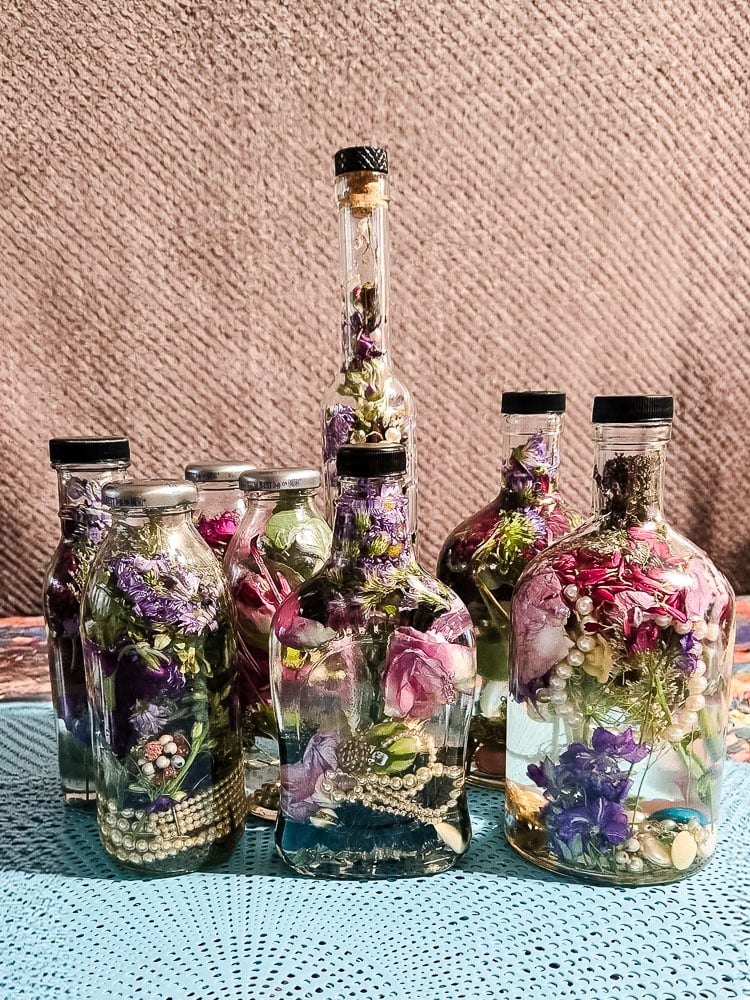 bottles filled with flowers suspended in oil