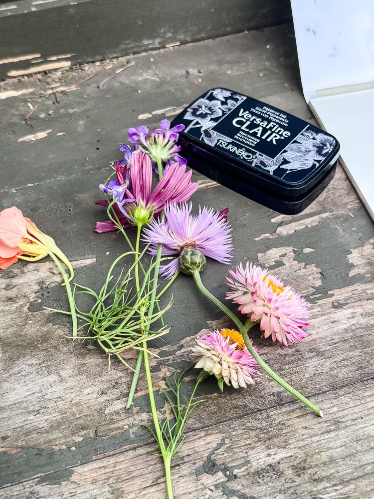 flowers and an ink pad on a green table