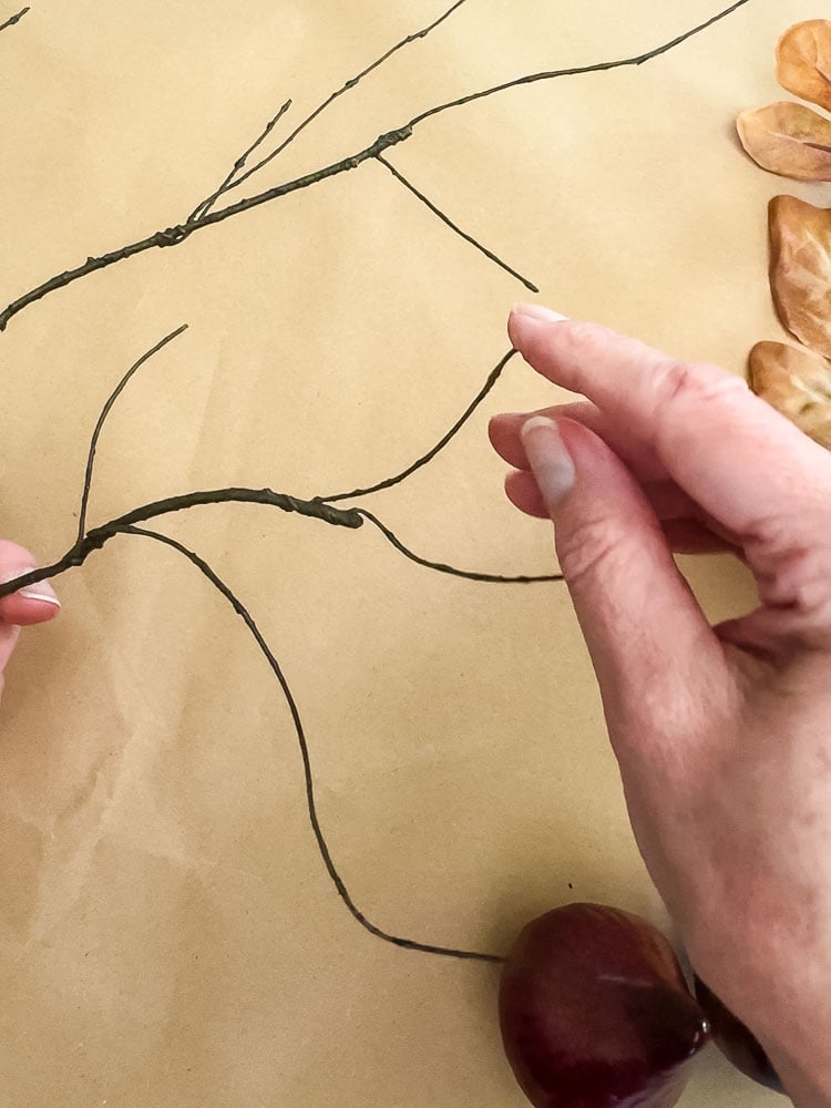 a woman hand bending an artificial twig