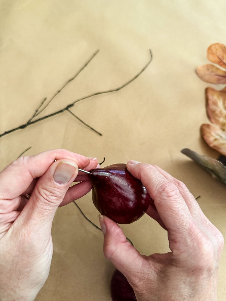 a woman holding an artificial fig 