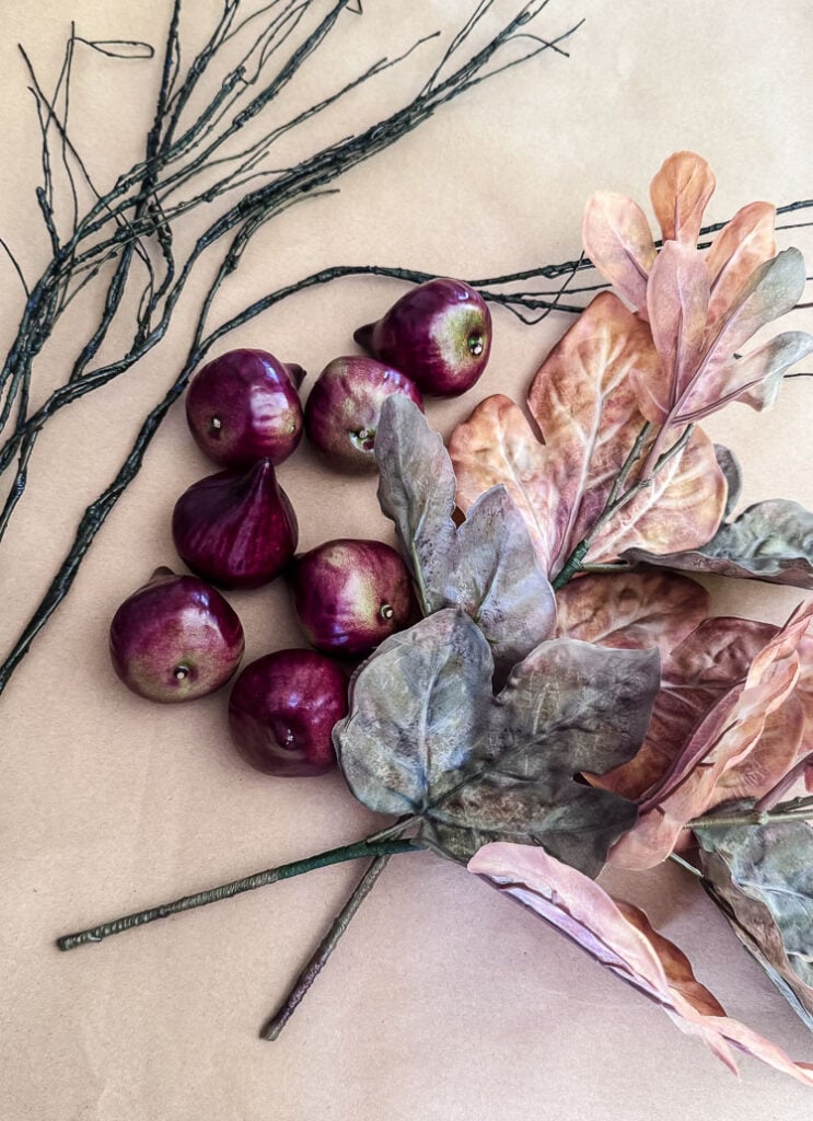 fake figs, fall leaf pick, and fake branches for a craft project
