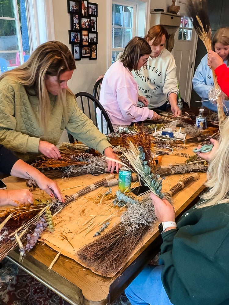 a table of women working on a fall craft