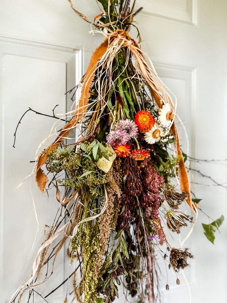 door swag made with dried flowers, weeds, and branches