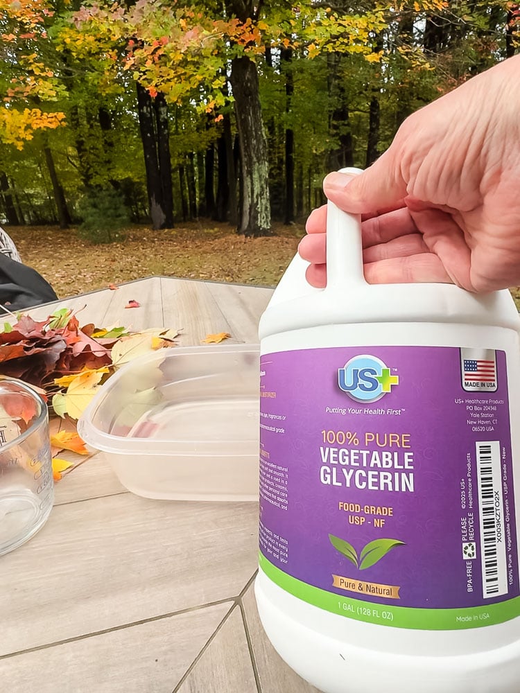 hand holding a jug of vegetable glycerin